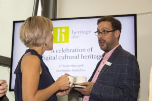 A man and woman chatting animatedly at Heritage Dot conference about digital cultural heritage