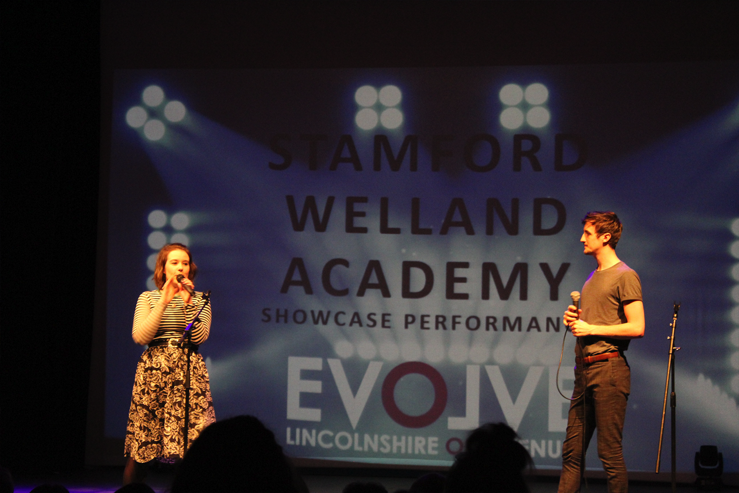Two young people performing onstage at a Lincolnshire One Venues event