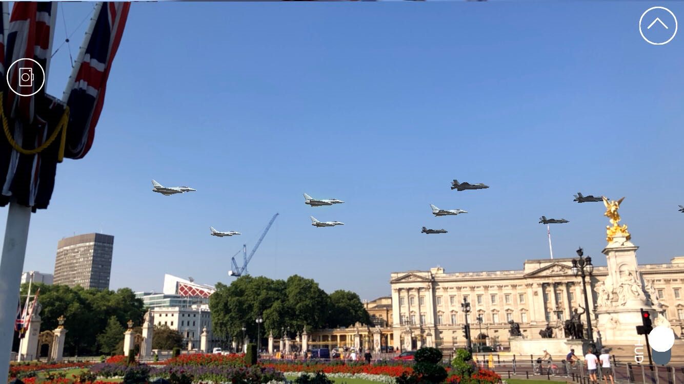 Image from the RAF 100 app of augmented reality planes flying over a city