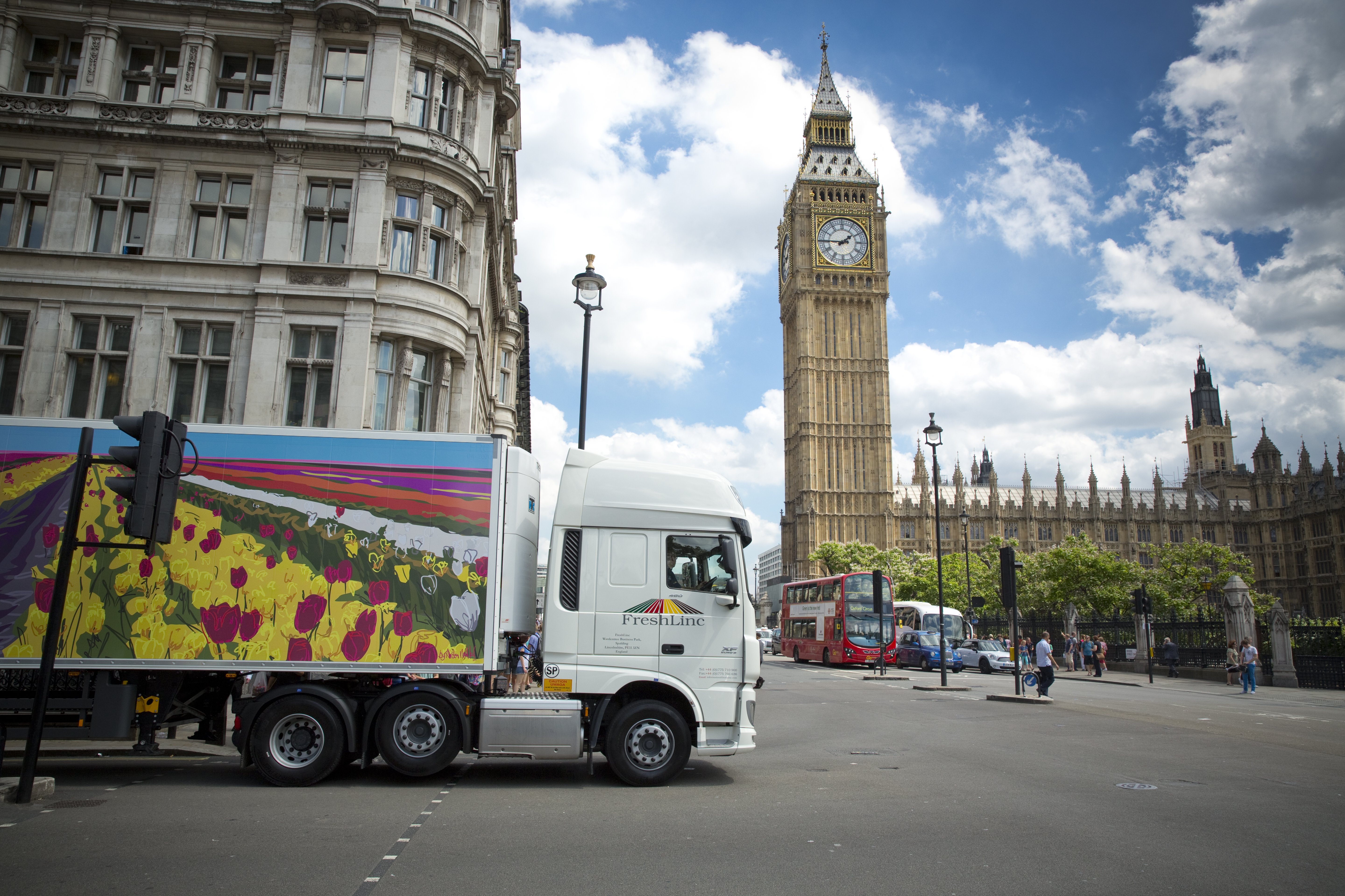 A lorry emblazoned with a landscape by a Lincolnshire artist drives past Big Ben